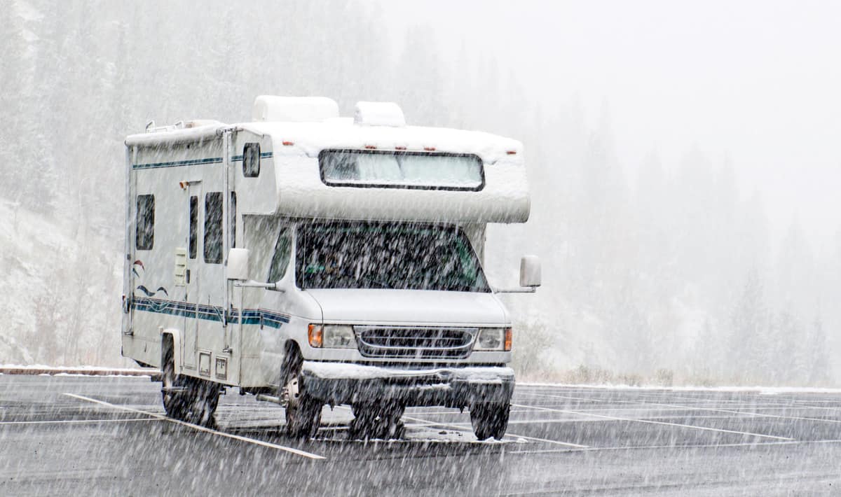 An RV parked on the road while raining, Which RVs Are Truly Four Season? (Including 11 Examples)
