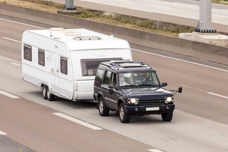 The best SUV for towing a travel trailer are the Ford Expedition, Chevrolet Tahoe, GMC Yukon, Chevrolet Suburban, Nissan Armada, and Toyota Sequoia, A Land Rover SUV towing an RV travel trailer in the highway, What's the Best SUV for Towing a Travel Trailer? (Inc. Six Recommendations)