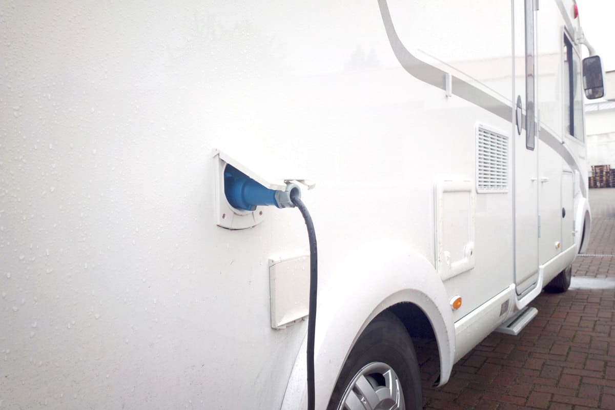 A parked camper van charging its batteries