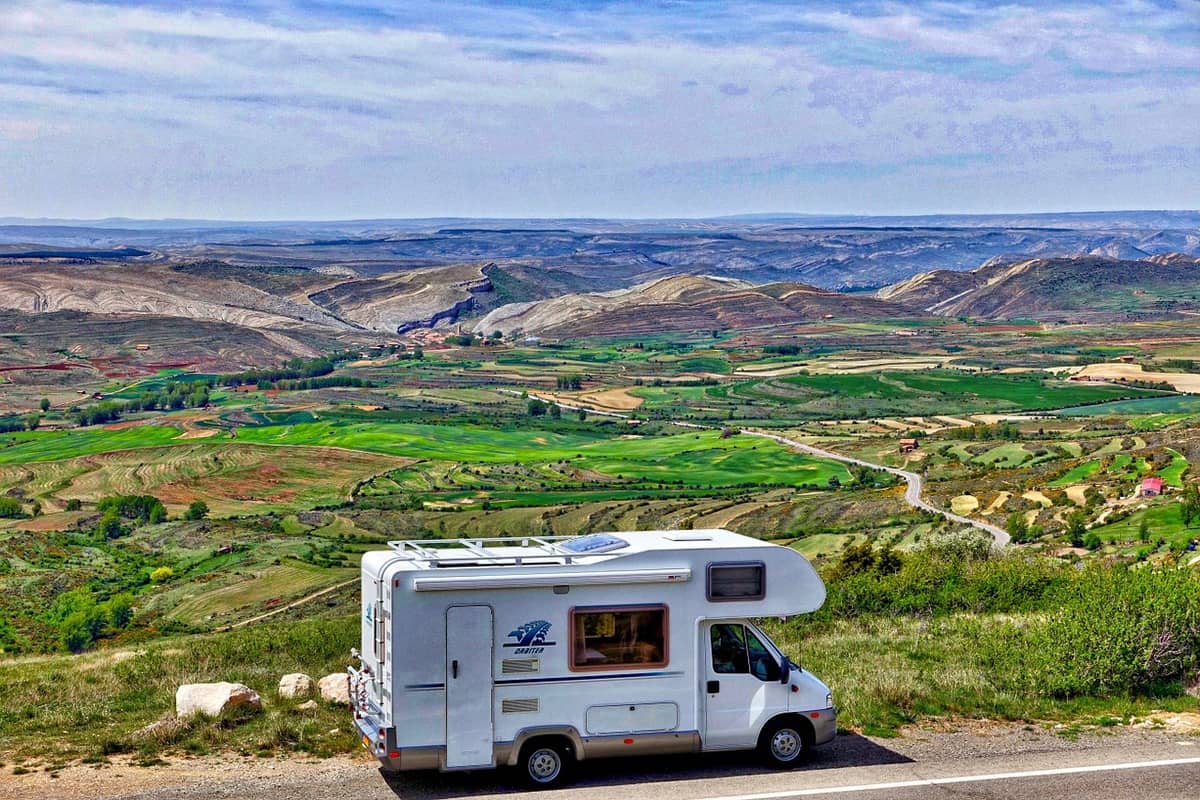 A motorhome driving along the road with scenic view