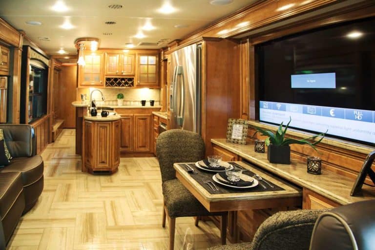 An interior of a modern RV kitchen with table for dining, 31 Stunning RV Interior Remodelling Ideas (With Pictures!)