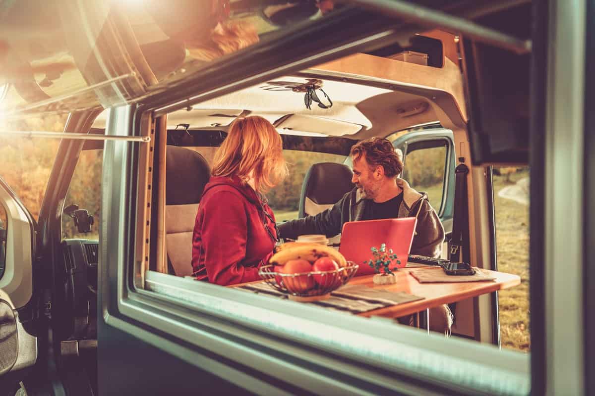 caucasian couple inside modern camper van