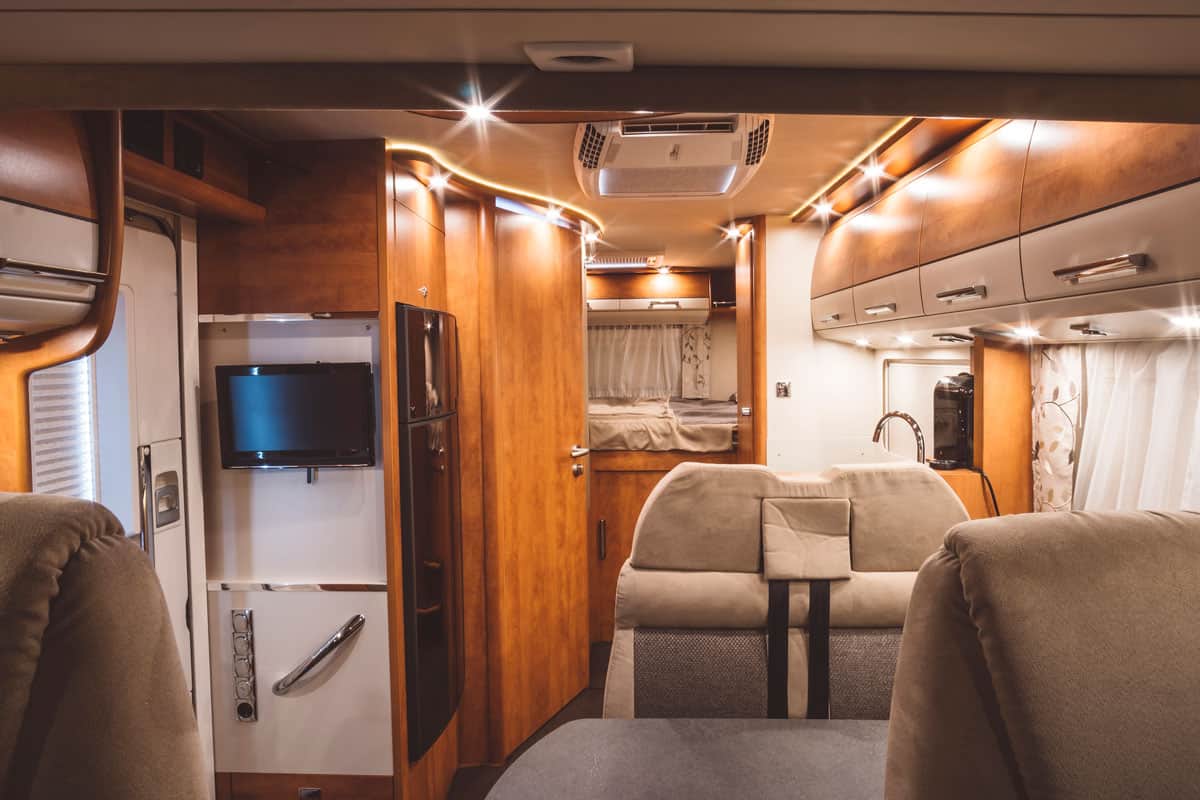 An interior of an RV that has wooden panels and cladding