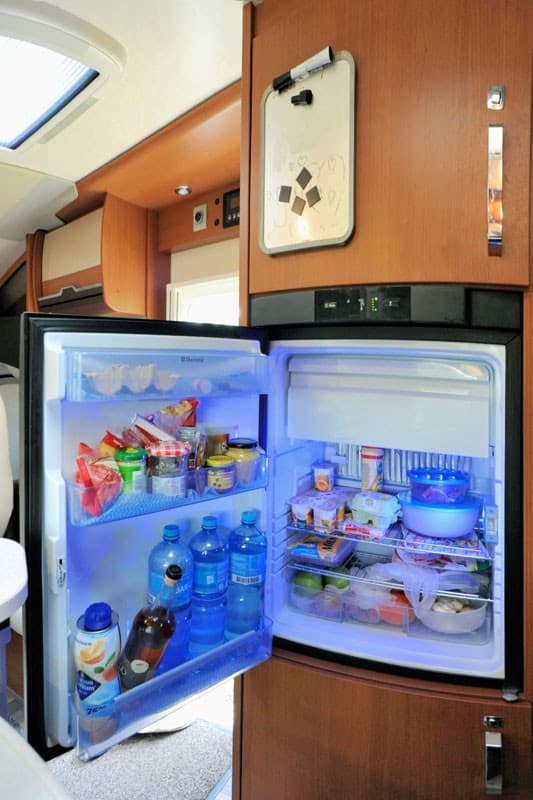 Refrigerator with all kinds of food in a luxury camper