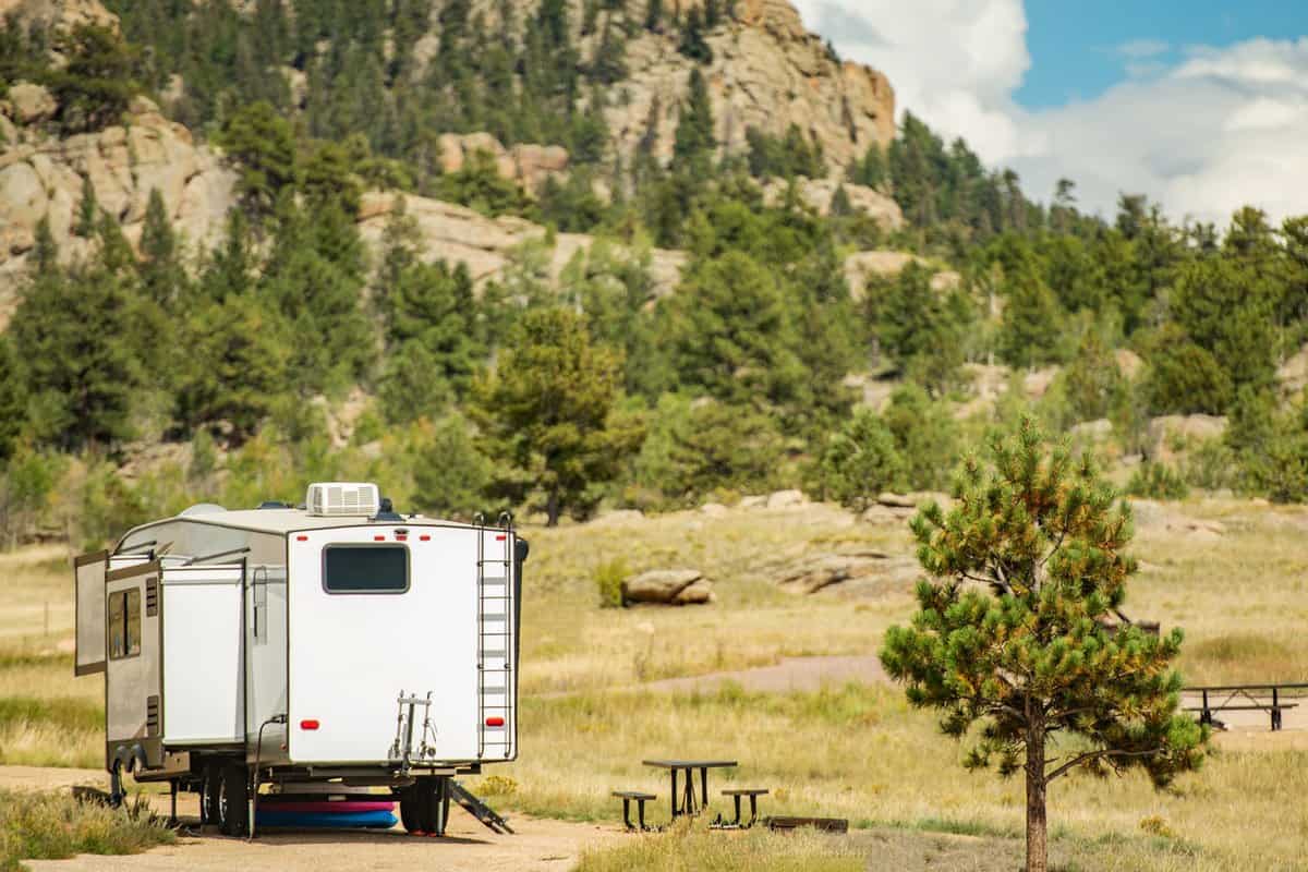 Fifth Wheel Travel Trailer Road Trip in the State of Colorado. Scenic Mountain Area RV Park. Recreational Vehicles Theme.