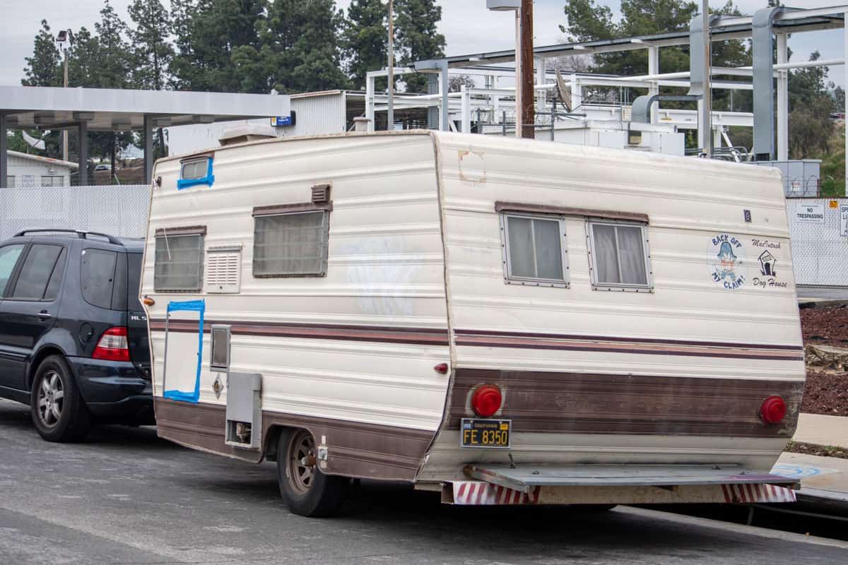 modern camper van parked on city sidewalk