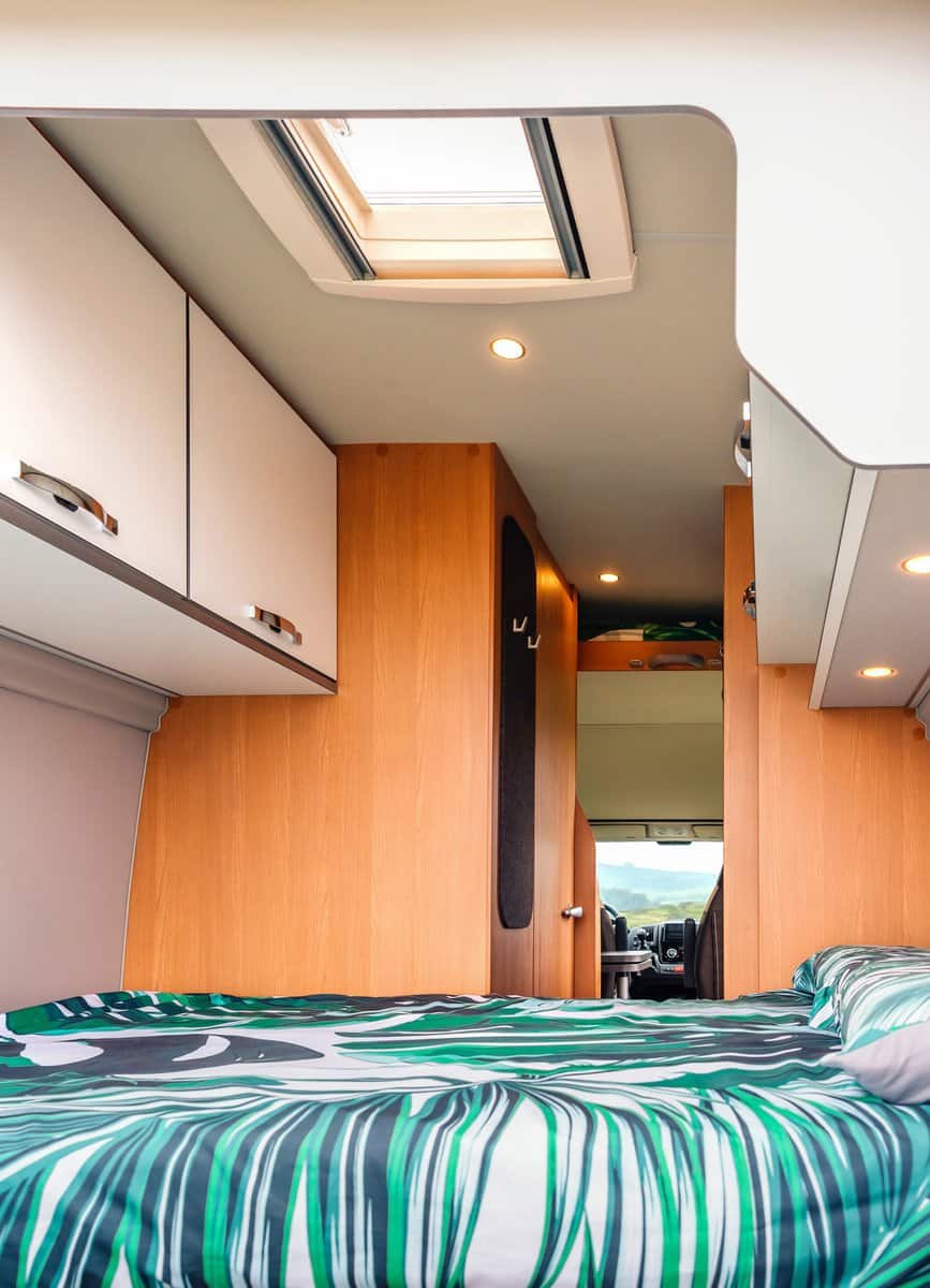 Interior of a camper van with double bed and skylight in the ceiling