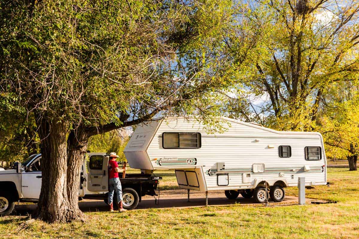 A small 5th wheel RV parked under the shade of the trees, What are the Smallest 5th Wheel RVs? [Inc. 11 examples]