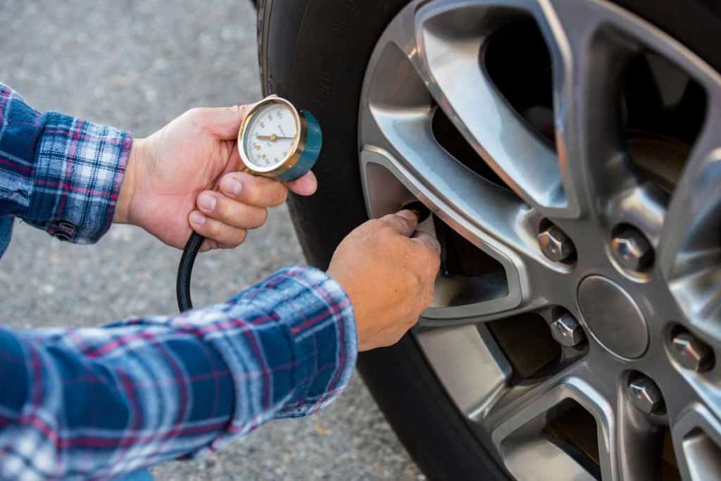 Man checking tire pressure