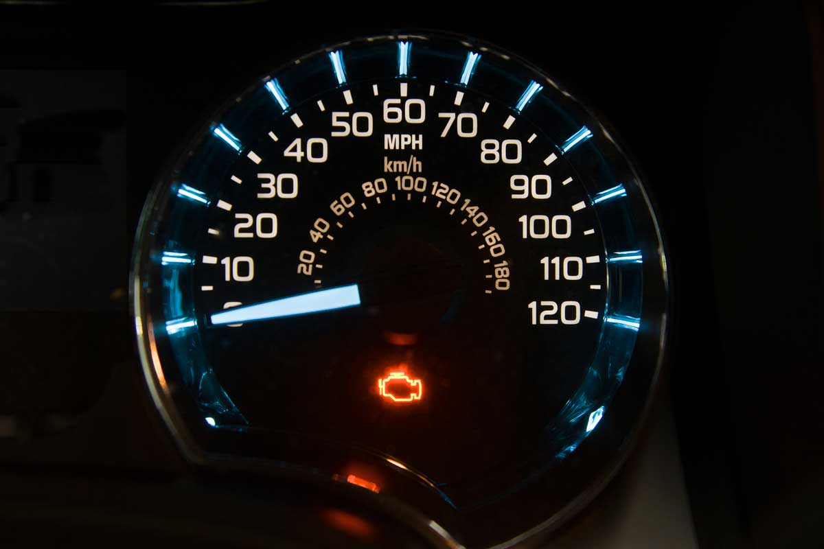 Yellow engine check engine icon on car dashboard