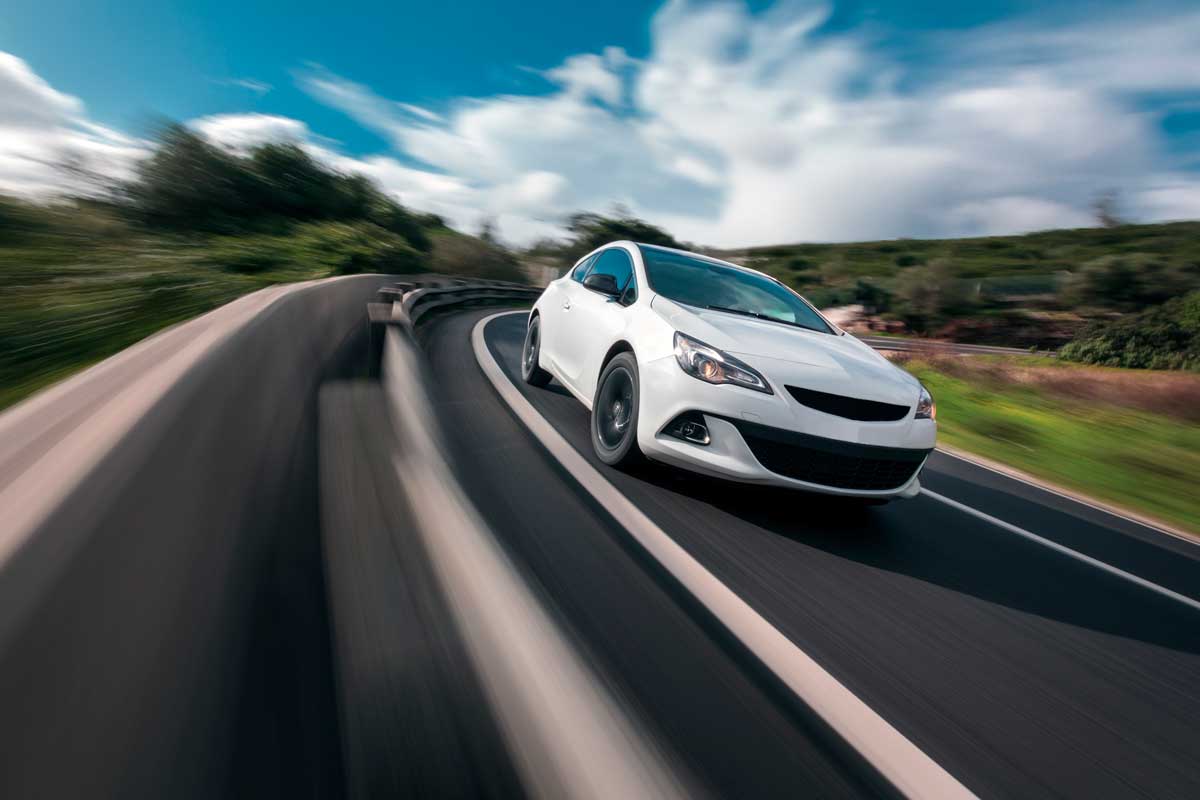 A car moving fast down a long stretch of highway, How Much Driving to Charge a Car Battery?