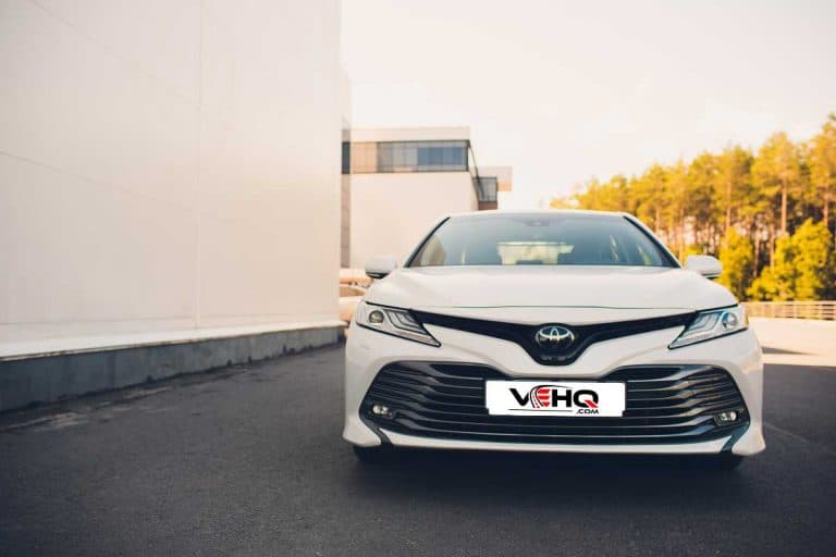 A white Toyota Camry parked outside a building, Toyota Camry Not Starting: What to Do?