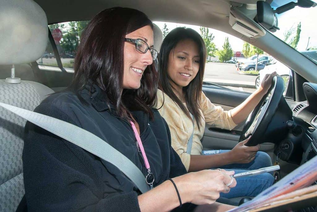 Driving instructor telling student about corrections