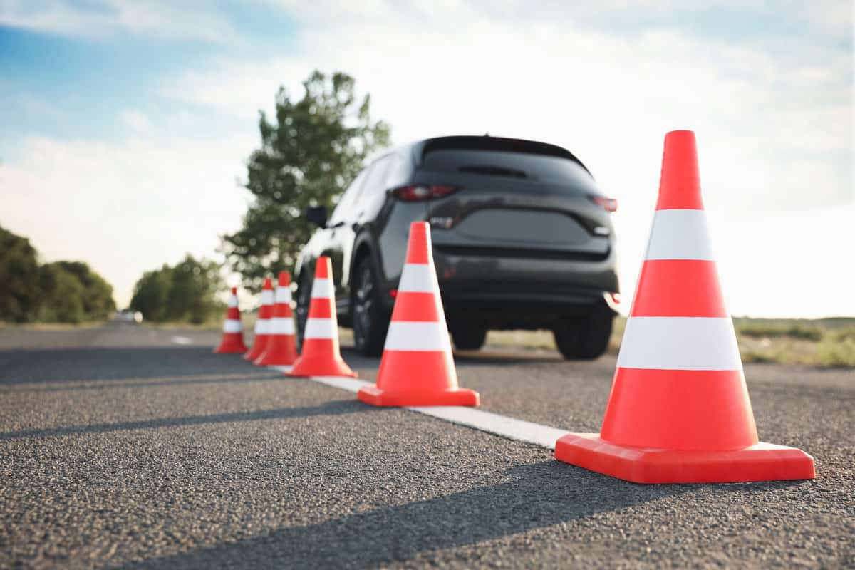 traffic cones near car outdoors driving