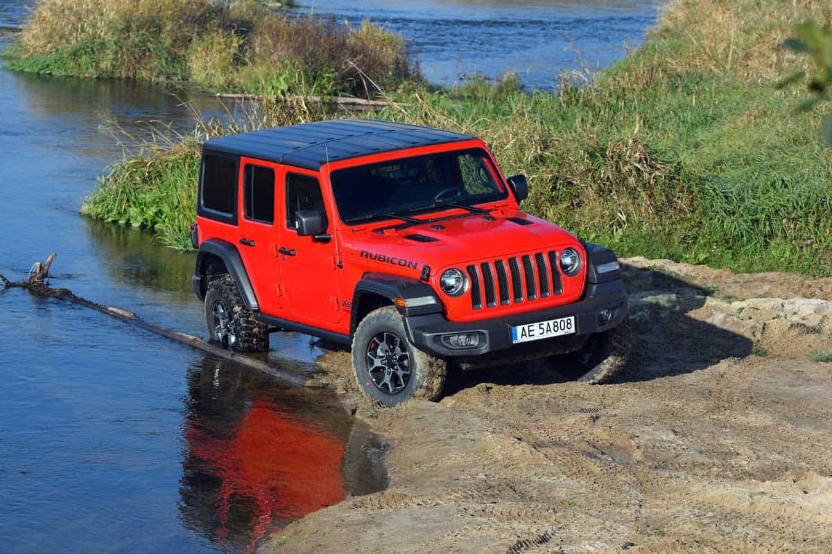 Red Jeep Wrangler Rubicon crossing stream, How Much Can a Jeep Wrangler Tow?