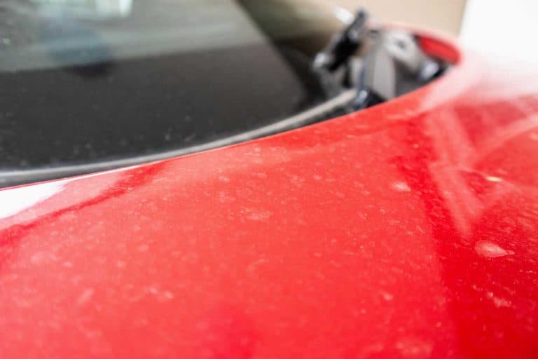 Dirty red car with water spots