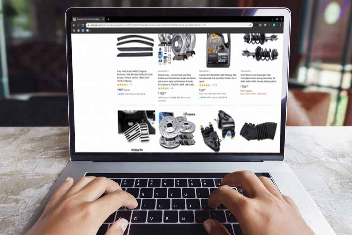 Man using laptop to shop online for honda parts, Where To Buy Honda Parts [Top 30 Online Stores]