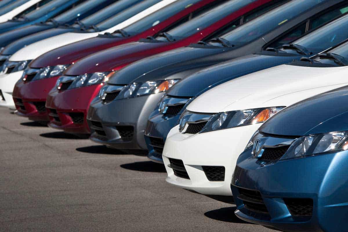 Row of new Honda Civic automobiles parked outside