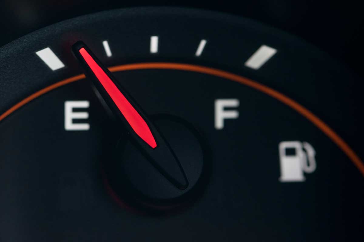Close-up car dash board petrol meter on black background.