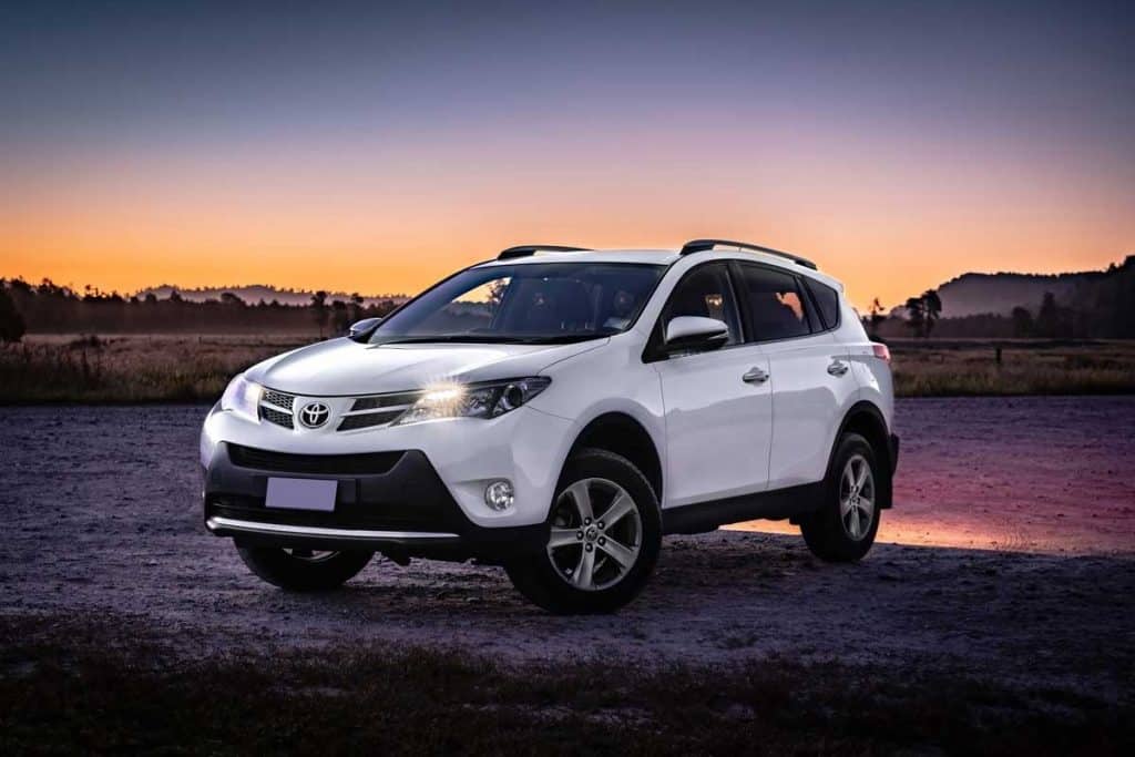 Toyota RAV4 parked in off-road with the view of sunset