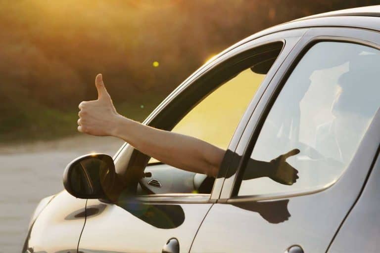 Man showing thumbs up from car window, 11 Unique Gifts For Car Lovers