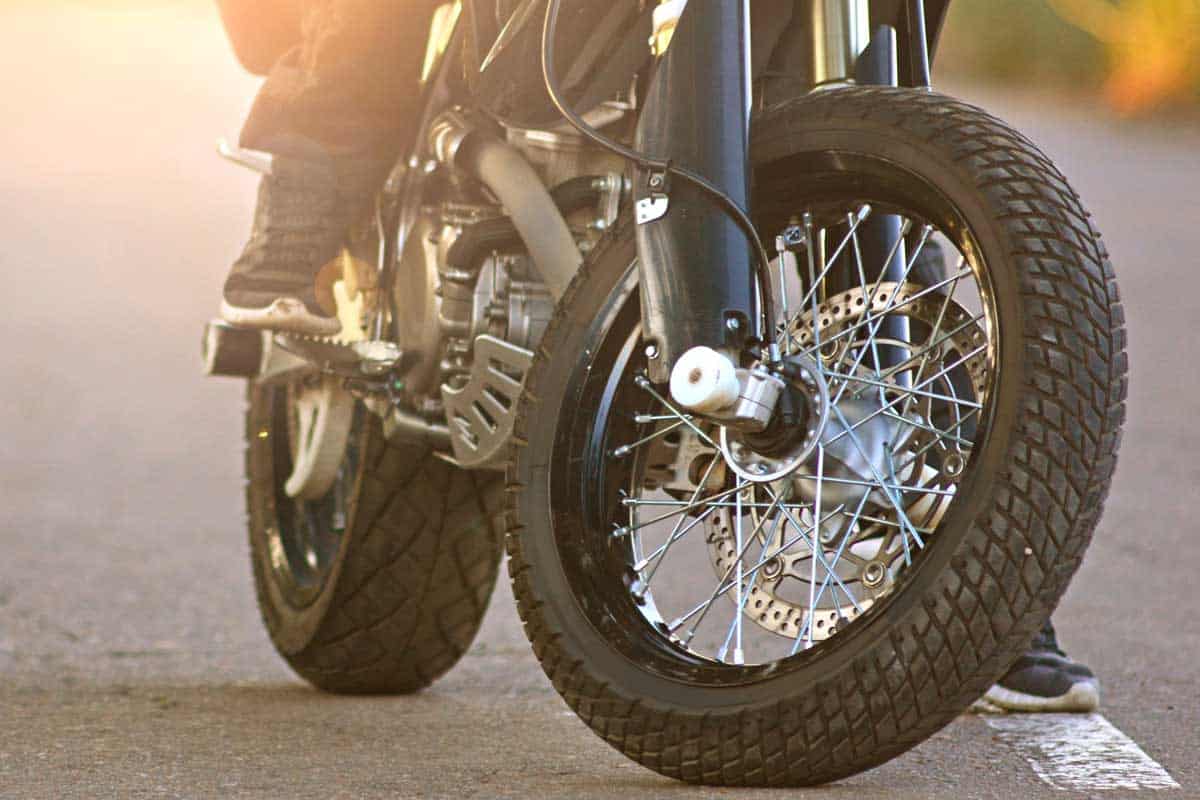 Motorcycle with biker on the asphalt road, Can A Motorcycle Tire Be Plugged Or Patched?