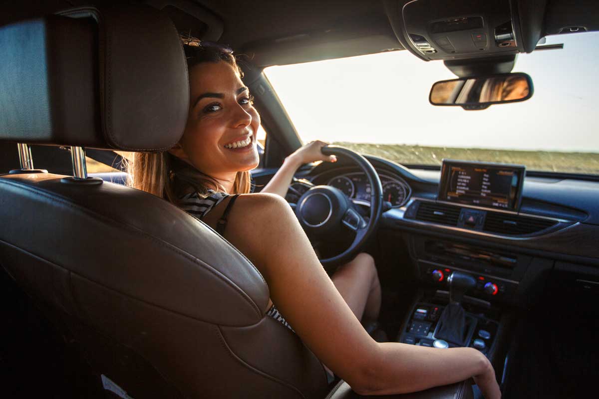 Smiling young woman going on a road trip