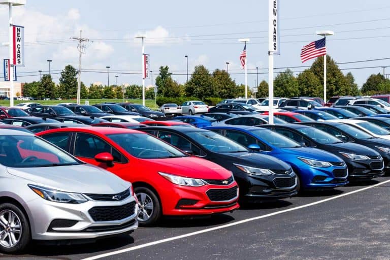 Chevrolet Automobile Dealership with American flag. Chevy is a Division of General Motors, What Is The Best Month To Buy A Car?