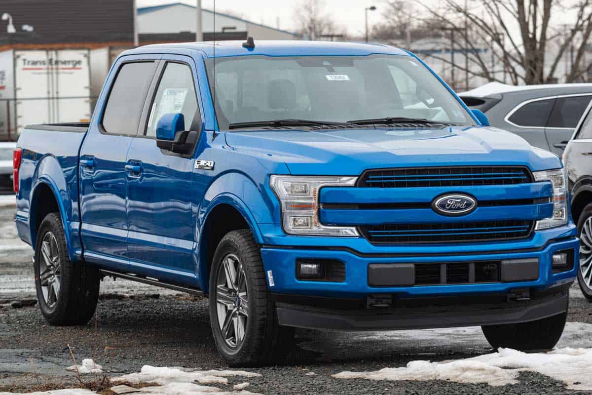 A blue 2020 Ford F-150 pickup truck at a dealership, Ford F-150 Models, Trim Levels, And Body Styles [Detailed Guide]