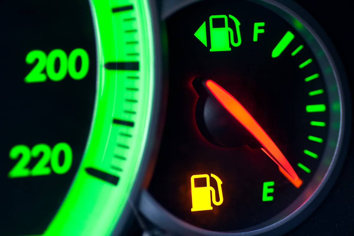 A close up photo of a gas gauge pointed at empty