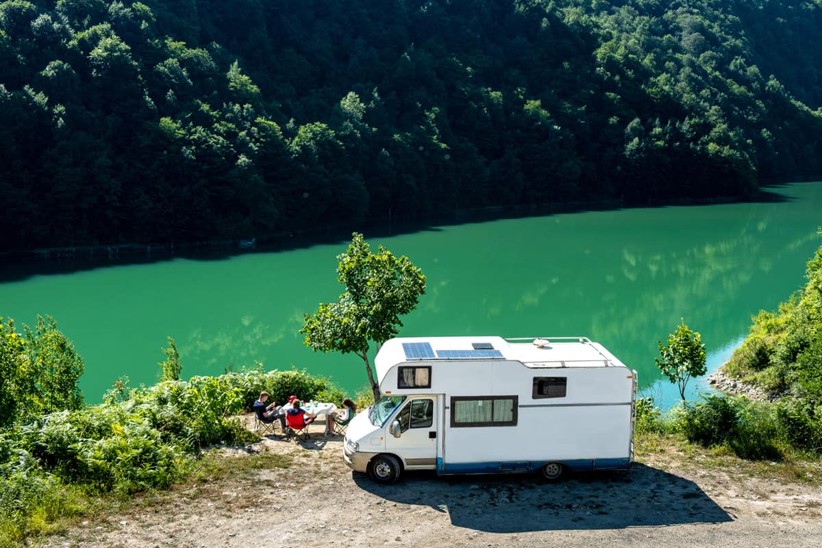 A motorhome near a mountain and a river, How To Deal With RV Water Damage [5 Simple Steps]