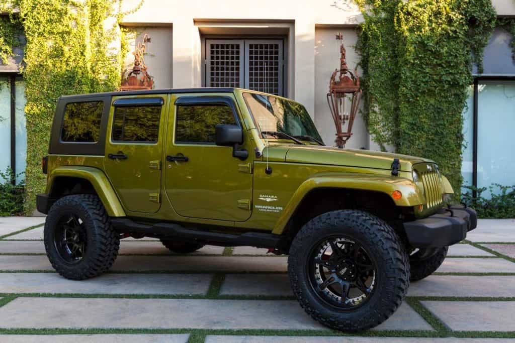 A parked Jeep Wrangler, this particular Jeep is known as the Sahara edition, What Jeep Wrangler Has Leather Seats? [Trim Level Explored]