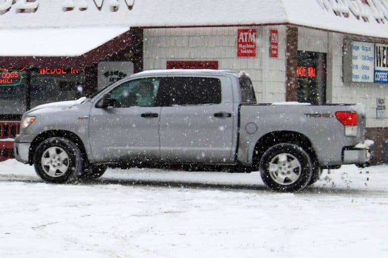 Gray pickup truck parked outside an inn during winter, Are Pickup Trucks Good in Snow?