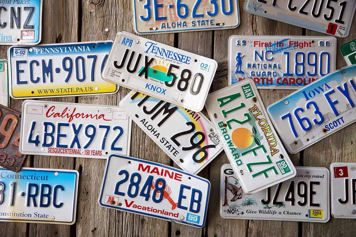 Old car license plates displayed on a wall