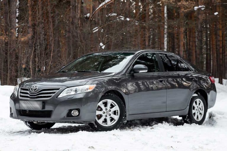 Gray Toyota Camry on a snowy road near the woods, Can a Toyota Camry Drive in Snow?
