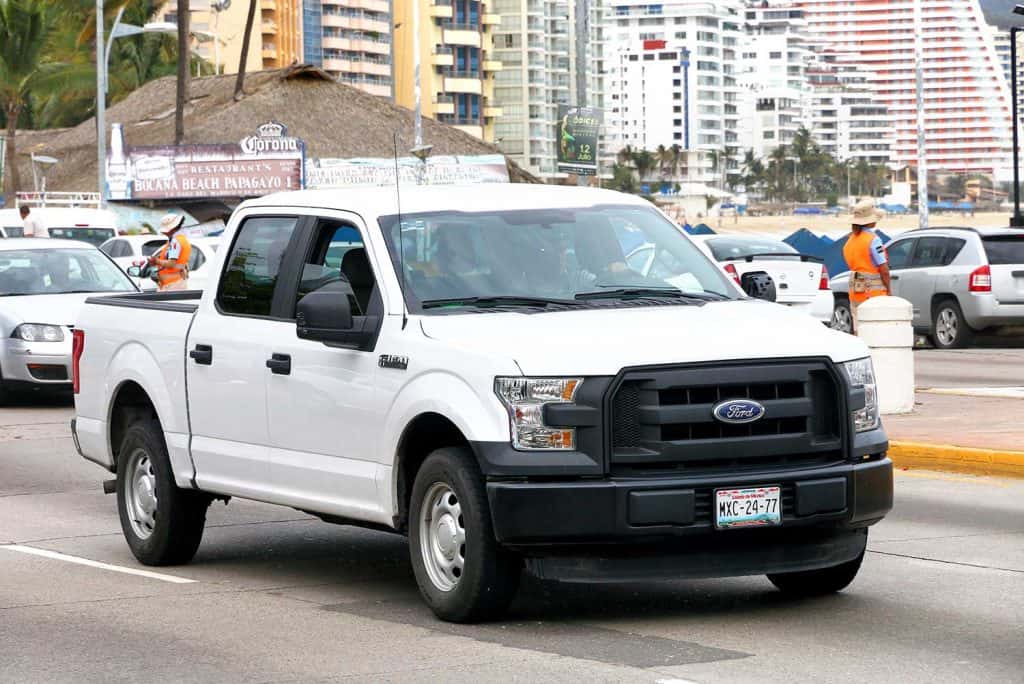 White pickup truck Ford F-150 in the city street