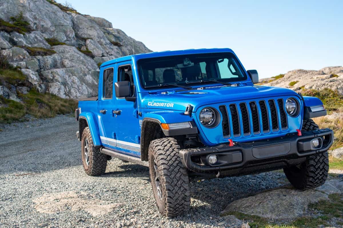 all new Jeep Gladiator blue color on the middle of the off road mountains