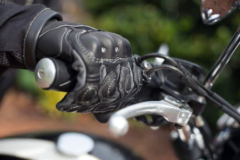 A close up photo of a leather glove of a motorcycle rider, Do Leather Motorcycle Gloves Stretch? [Yes! and Here are 5 ways to do just that!]