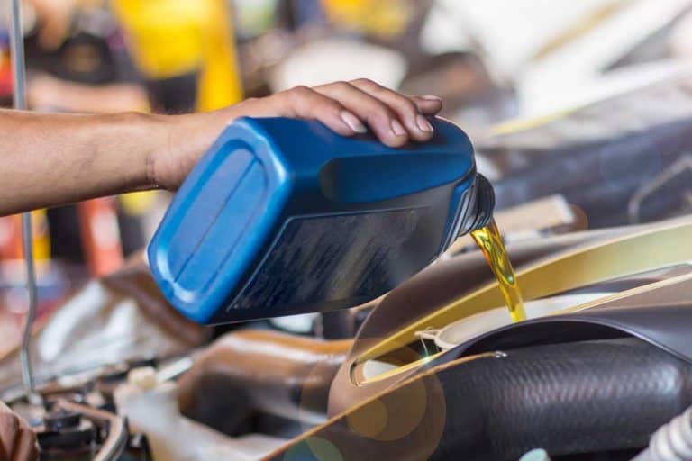 A man pouring oil to car engine, Does Castrol Motor Oil Contain Zinc?