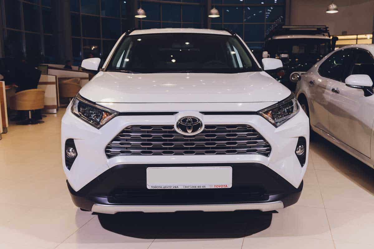 All-new compact crossovers Toyota RAV4 premier at Toyota car standing next to showroom entrance front view