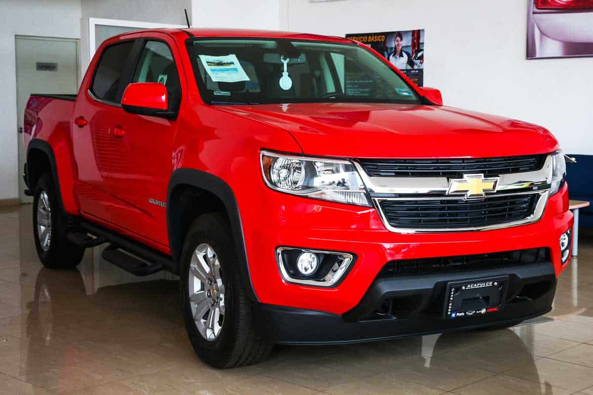 Brand new pickup truck Chevrolet Colorado in a car dealership, How Much Can You Tow with a Chevy Colorado?