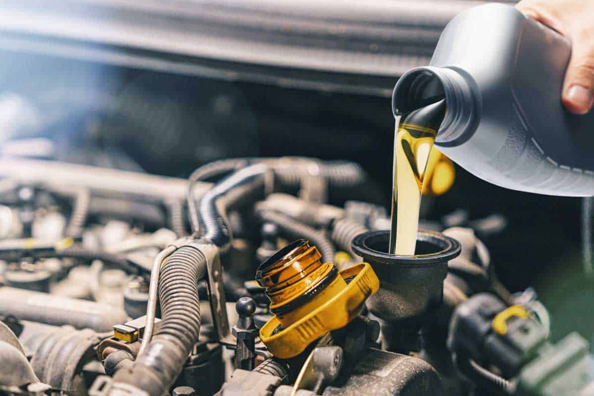 Fresh motor oil poured to car engine, Will Synthetic Oil Make Your Engine Last Longer?