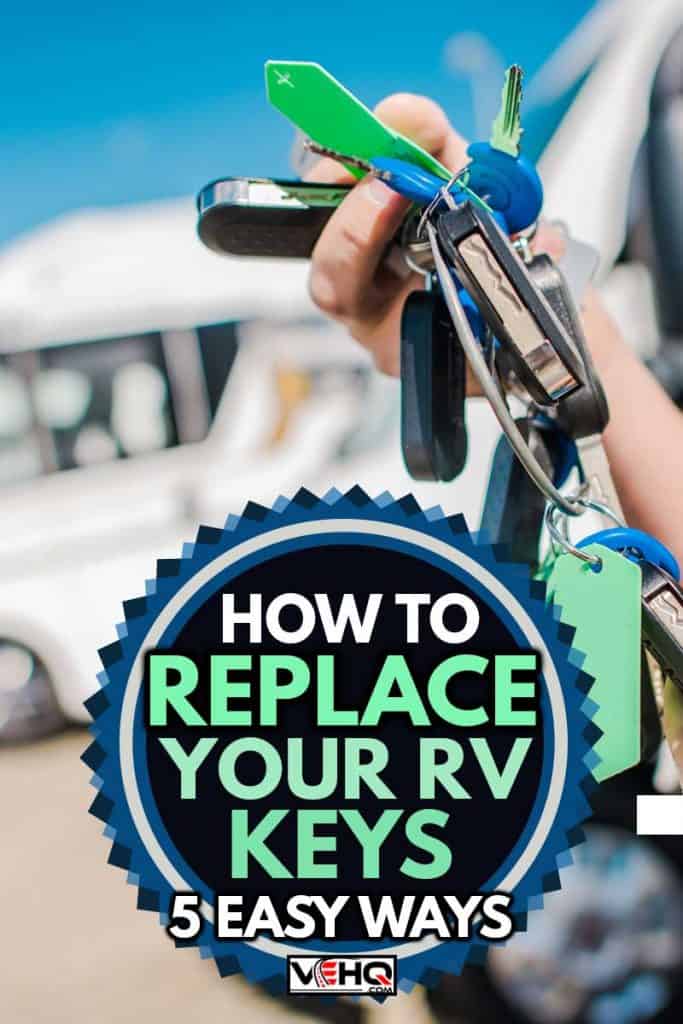 A man's hand holding keys in front of his RVs, How To Replace Your RV Keys [5 Easy Ways]