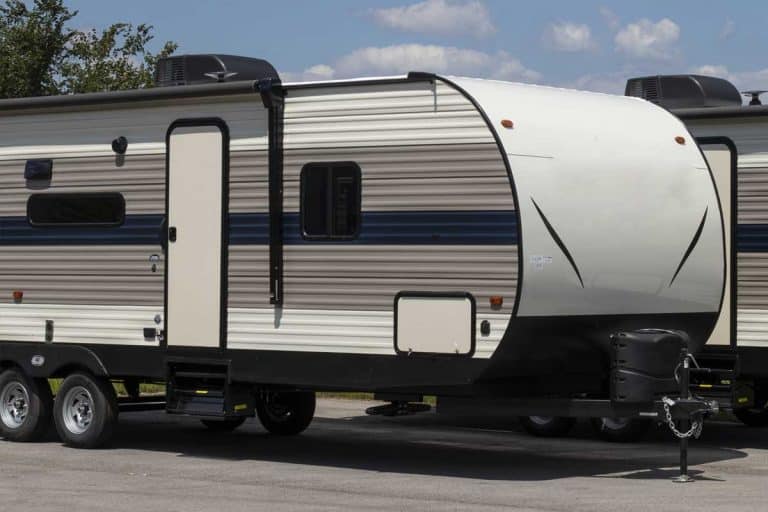 Luxury motorhome RV parked in a sunny day, Luxury Pull-Behind Campers [9 Models You Should Check Out]