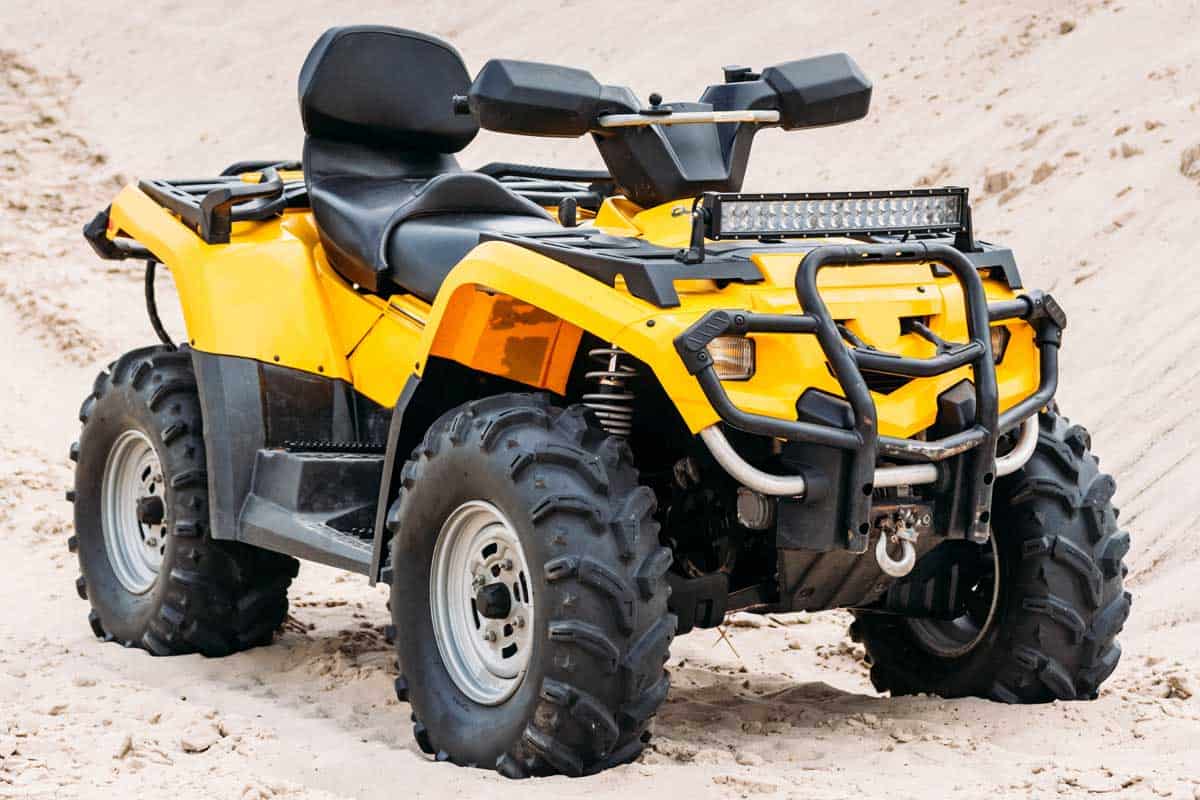 Modern yellow all-terrain vehicle standing in desert, How Much Does An Arctic Cat ATV Cost?