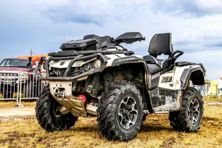 Quad bike Can-Am BRP Outlander is parked at the countryside, How Long Is An ATV?