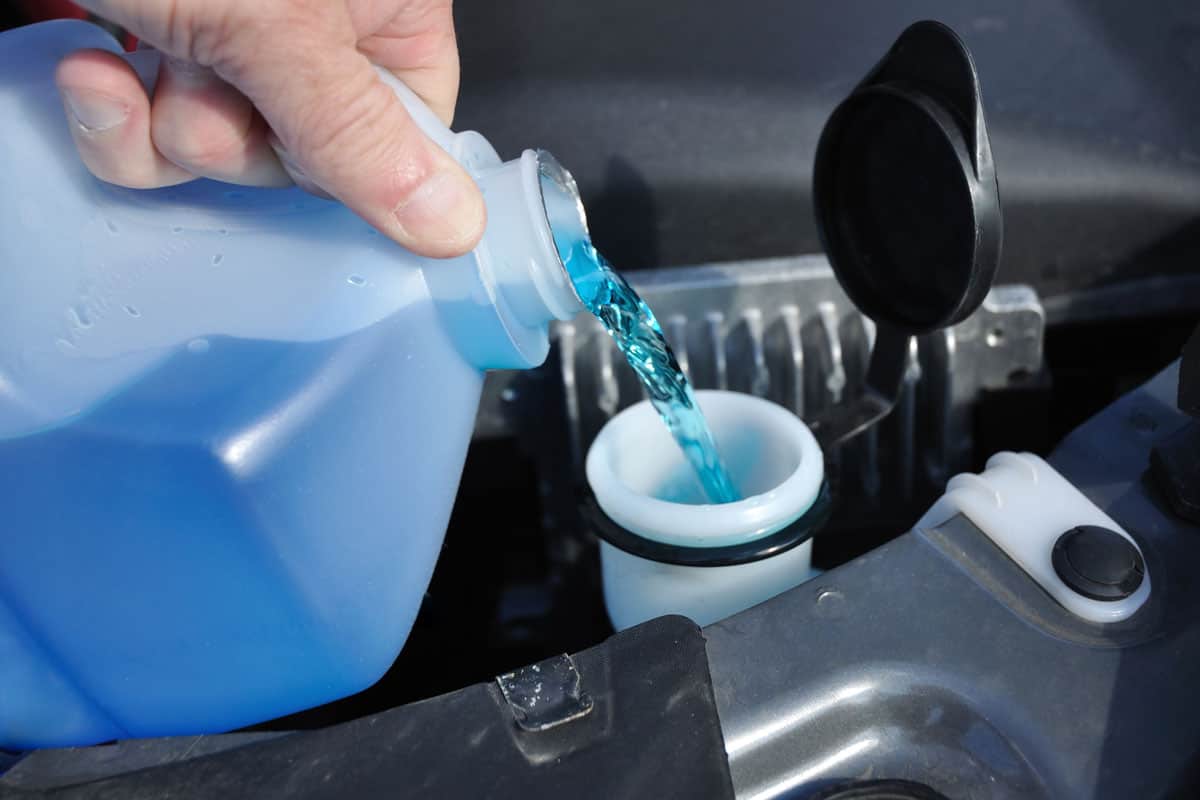 pouring-antifreeze-liquid-washing-car-screen