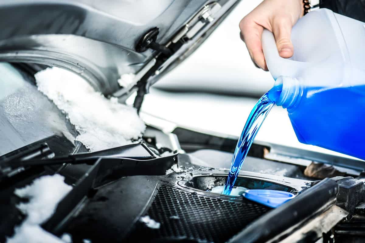 pouring-antifreeze-liquid-washing-car-screen