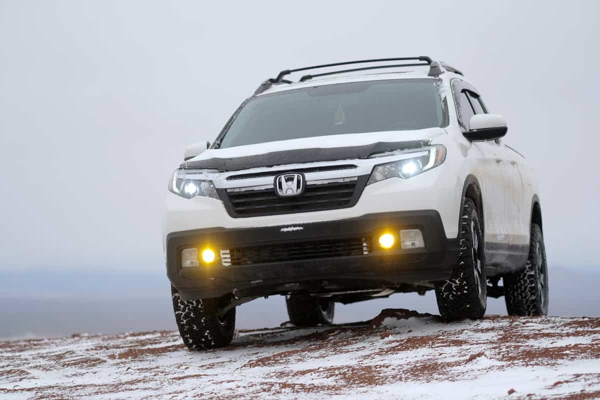A Honda Ridgeline trekking on a snowy terrain under heavy fog with low visibility, Is the Honda Ridgeline a 4WD?
