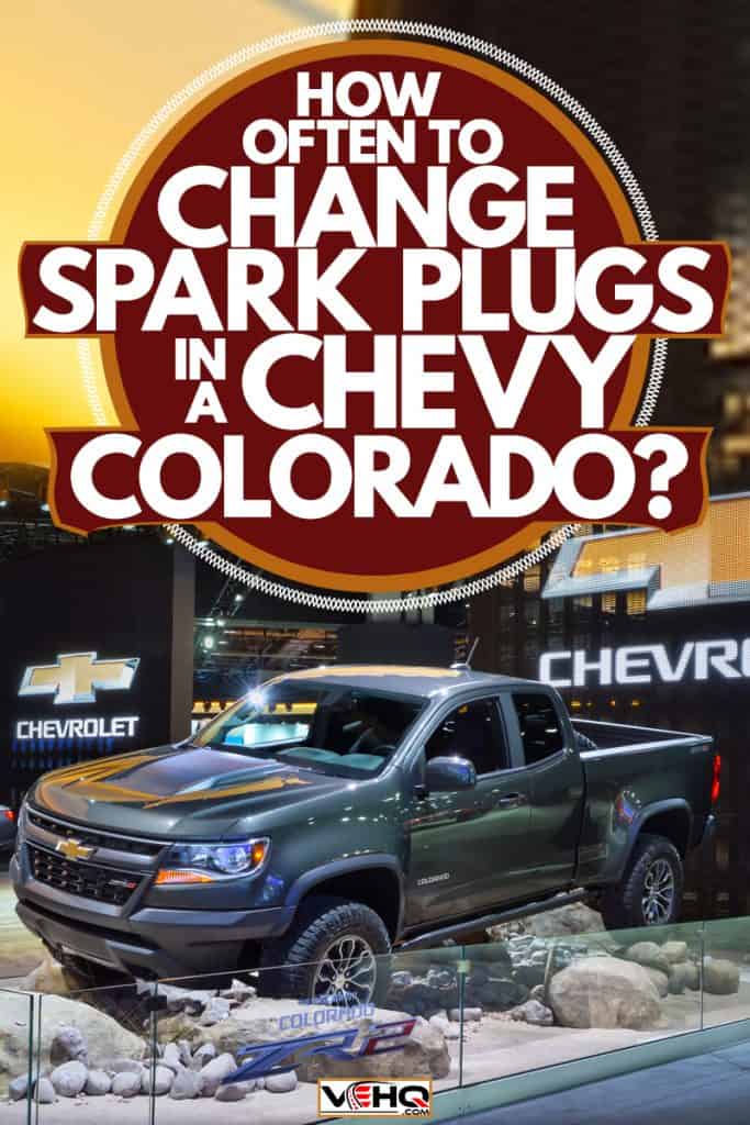 A Chevrolet Colorado on a rocky terrain display at a car show, How Often to Change Spark Plugs in a Chevy Colorado?